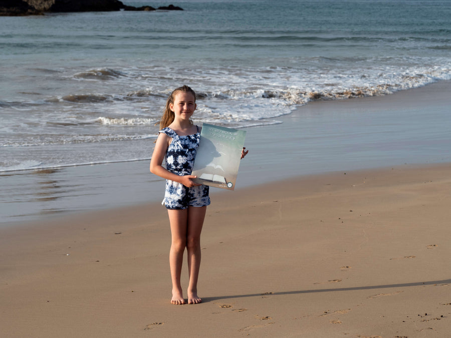 Enlighten Press publisher photograph showing the large Big Book format beside a child.